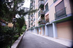 an empty street next to a row of apartment buildings at Inn Rhome 71 in Rome