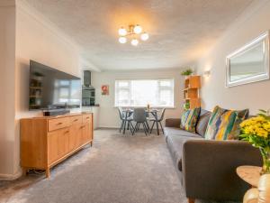 a living room with a couch and a table at Silverdale Secret Gem with Private Garden Pass the Keys in Newcastle under Lyme