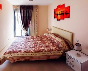 a bedroom with a large bed and a window at MuchoSol in Benidorm