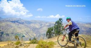 a man is riding a bike on a hill at Refugio Viñak 