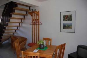 a dining room with a table and a staircase at Ferienwohnungen Meyer in Bollewick