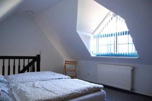 a bedroom with a bed and a large window at Ferienwohnungen Meyer in Bollewick