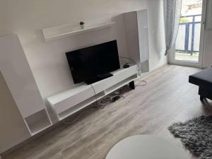 a living room with a flat screen tv on a wall at MiDo in Zalaegerszeg