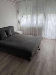 a bedroom with a bed and a wooden floor at MiDo in Zalaegerszeg