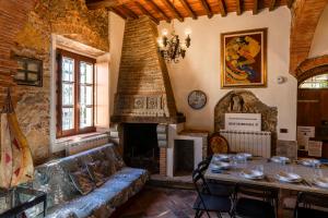 a living room with a table and a fireplace at Vacation Home Tuscany Pisa-Lucca 1 in Filettole