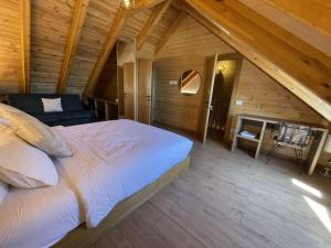 a bedroom with a large bed in a wooden house at Buni i Bajraktarit in Bogë
