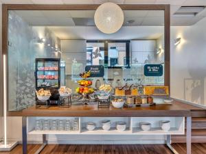 a display window of a bakery with food on display at B&B HOTEL Milano Portello in Milan