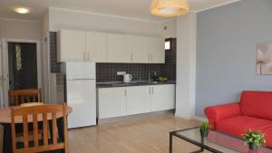 a kitchen and a living room with a red couch at Apt El Molino 2B in Valle Gran Rey