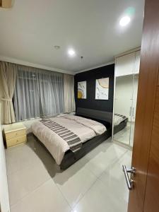 a bedroom with a bed and a walk in shower at Spacious living room Hampton's Park Apartment in Jakarta +12 photos