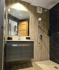 a bathroom with a shower and a sink and a mirror at Granny's Woods Cottage in Ranau +22 photos