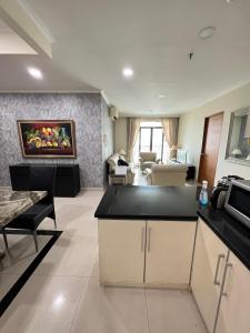 a room with a kitchen and a living room at Spacious living room Hampton's Park Apartment in Jakarta