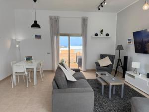a living room with a couch and a table at Fuerteventura Velvet Golf in Antigua