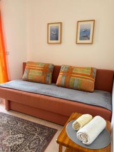 a couch with pillows and a table in a room at Villa Maslina in Zadar
