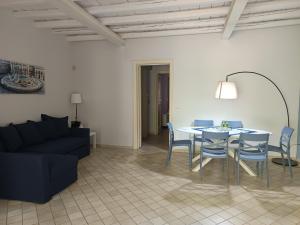 een woonkamer met een tafel, stoelen en een bank bij Dimora Artale Suite in Palermo +16 foto's