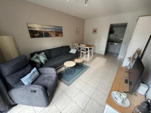 a living room with a couch and a table at UG-Buche in Göhren-Lebbin