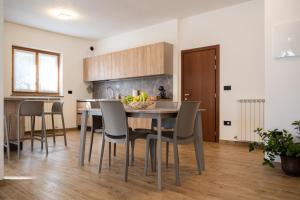 a kitchen with a table with a bowl of fruit on it at Casa Beccaria in Lovero Valtellino