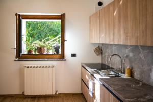 a kitchen with a sink and a window at Casa Beccaria in Lovero Valtellino +27 photos