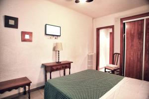 Postel nebo postele na pokoji v ubytování Hostal Isabel