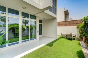 an exterior view of a house with green grass at PVH - Chic 3BR Villa with Backyard - Albizia in Dubai