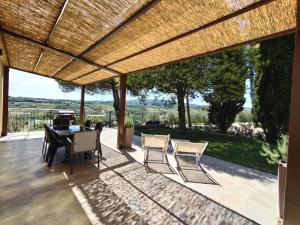 a patio with a table and chairs and a view at Agriturismo Poggio Rotondo in San Gimignano