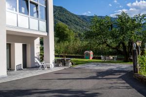 a building with a patio with a table and chairs at Casa Beccaria in Lovero Valtellino