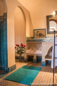 a room with two beds and a fireplace at Tigmi Nomade in Tahannout