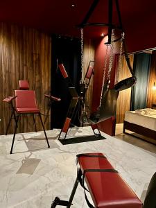 a room with two red chairs and a bed at Dual Experience Love Room pour 2 à 4 personnes in Port-de-Bouc