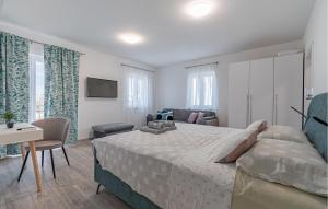 a bedroom with a bed and a living room at 5 Bedroom Nice Home In Vidulini in Vidulini