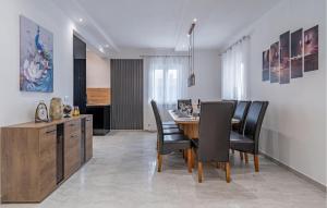 a kitchen and dining room with a table and chairs at 5 Bedroom Nice Home In Vidulini in Vidulini