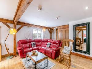 a living room with a red couch and a table at The Lodge in Gloucester