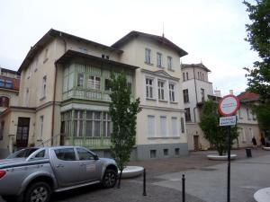 a car parked in front of a large building at Apartament Sunset in Sopot