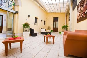 
a living room filled with furniture and a large window at Residence Cortile Mercè in Trapani
