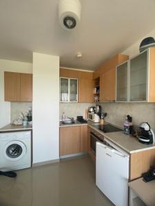 a kitchen with a dishwasher and a washer and sink at M&V House in Balchik