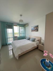 a bedroom with a large bed and a table at M&V House in Balchik