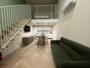 a living room with a green couch and a table at Residenza Lidia e Giulia in Grottammare