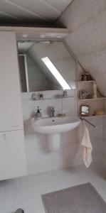 a bathroom with a sink and a mirror at Ferienwohnung Paula in Buxtehude