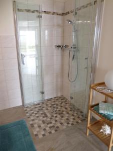 a bathroom with a shower with a glass shower stall at Haus Sonnenhof am Dollart 45240 in Ditzumerhammrich +34 photos