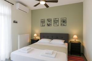 a bedroom with two beds and two night stands at Billy's Place in Egina