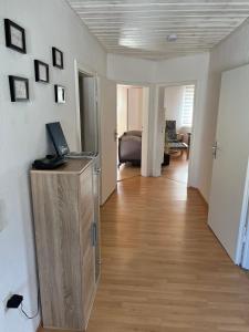 a room with a hallway with a desk with a laptop on it at Ferienwohnung Seerose in Hemfurth-Edersee