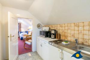a kitchen with a sink and a microwave at Strandvilla DG in Bansin