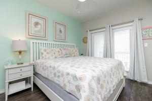 a bedroom with a bed and a window at Fun 4 Bedroom - Resort Pool Sleeps 12 in Port Aransas