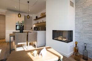 ein Wohnzimmer mit Tisch und Kamin in der Unterkunft Beachhouse Bansin, App. 06 in Bansin