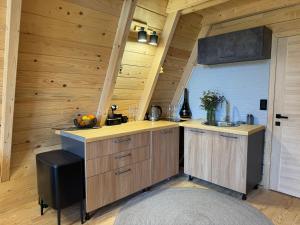 a kitchen with wooden cabinets and a sink at Hygge villa in Žabljak