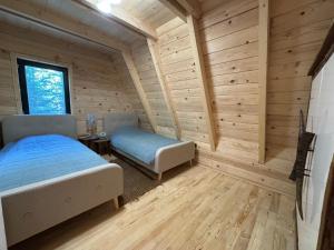 a bedroom with a bed and a bench in a room at Hygge villa in Žabljak