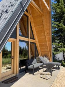 a large glass door on a house with a patio at Hygge villa in Žabljak +2 photos