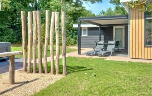 a group of bamboo poles in a yard with a house at Awesome Home In Voorthuizen in Voorthuizen