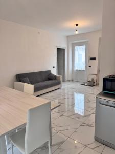 a living room with a couch and a table at appartamento Tortona in Tortona