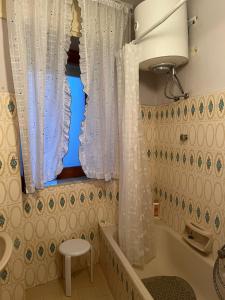 a bathroom with a tub and a sink and a window at Guest house Natalina in Gioiosa Ionica +34 photos