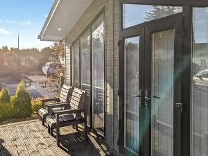 a porch with two benches on a house at Zion's Retreat in Plumbland
