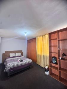 - une chambre avec un lit et un rideau jaune dans l'établissement Habitación céntrica bonita vista, à Arequipa